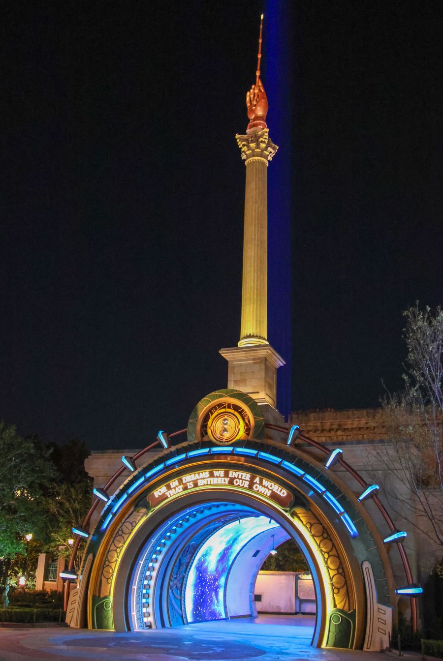 The lit-up portal into the Wizarding World of Harry Potter – Ministry of Magic at Epic Universe at night