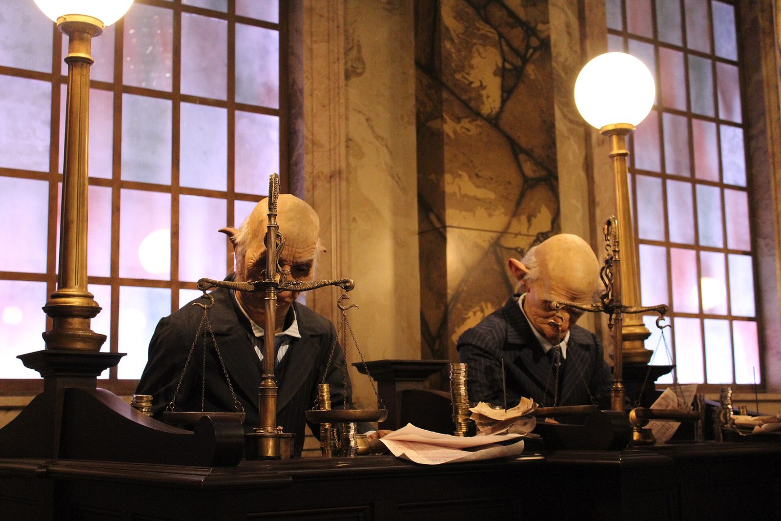 Animatronic goblin tellers inside the Gringotts bank lobby queue at Universal Studios Florida