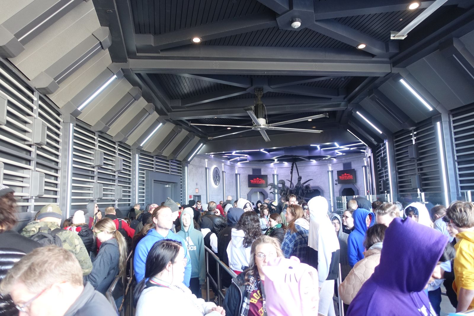 Guests waiting in the first queue room of Jurassic World VelociCoaster at Islands of Adventure