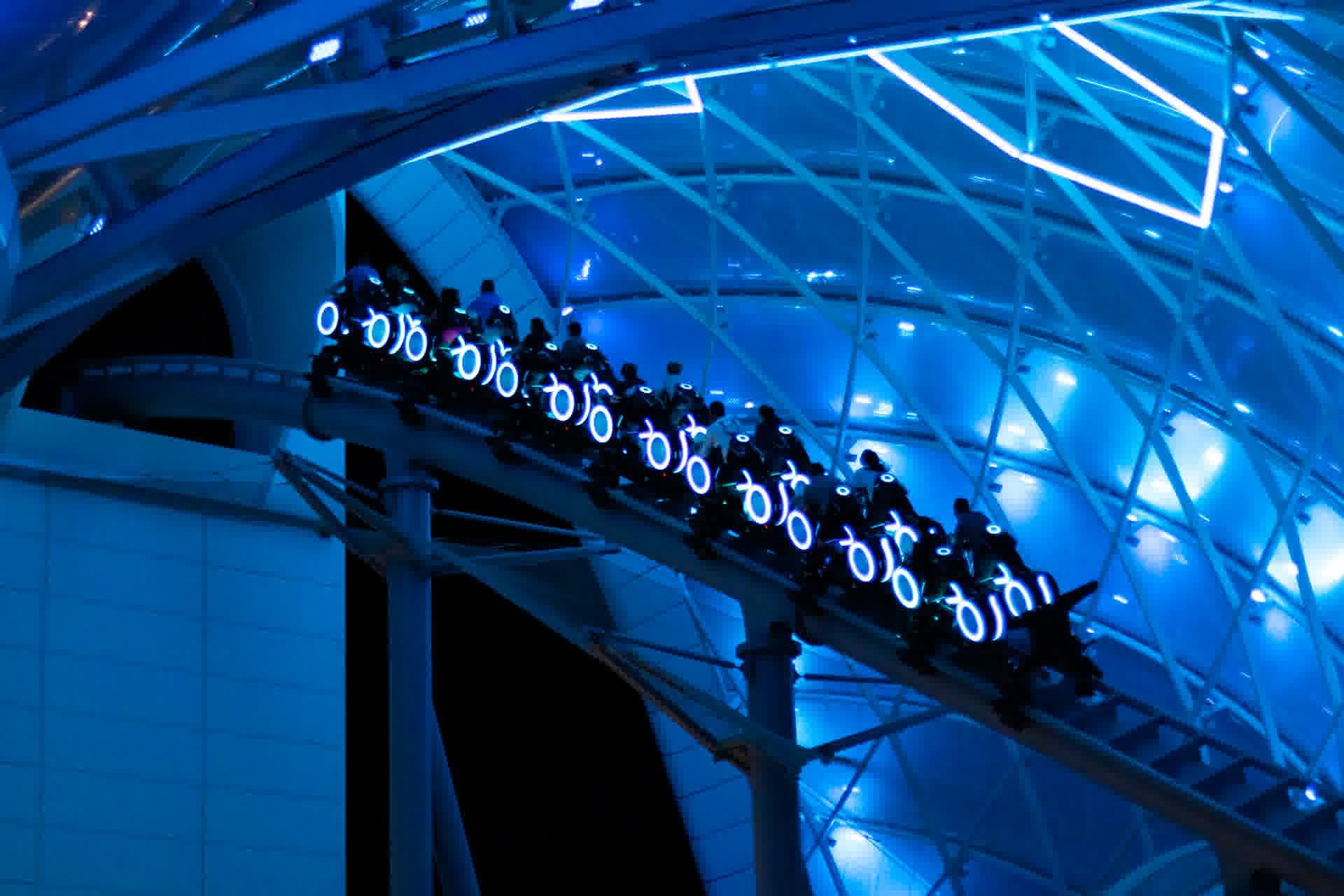 TRON Lightcycle Run lit up at night at Magic Kingdom